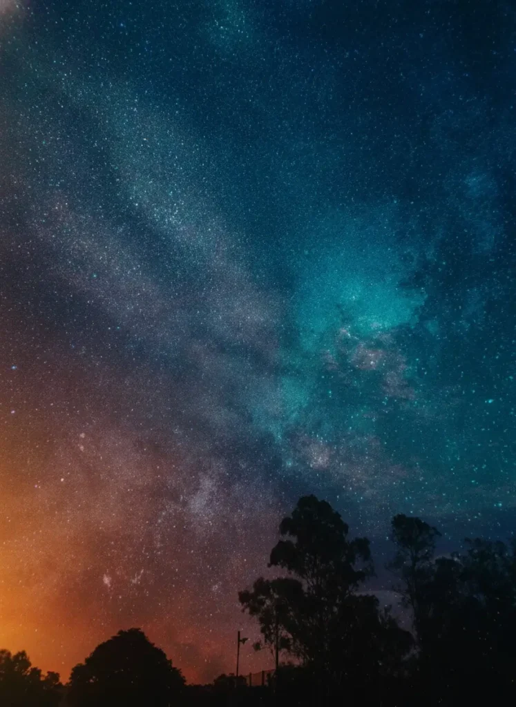 Starry galaxy night sky with deep blue tones and dark silhouettes, ultra HD dark AMOLED wallpaper for mobile and desktop