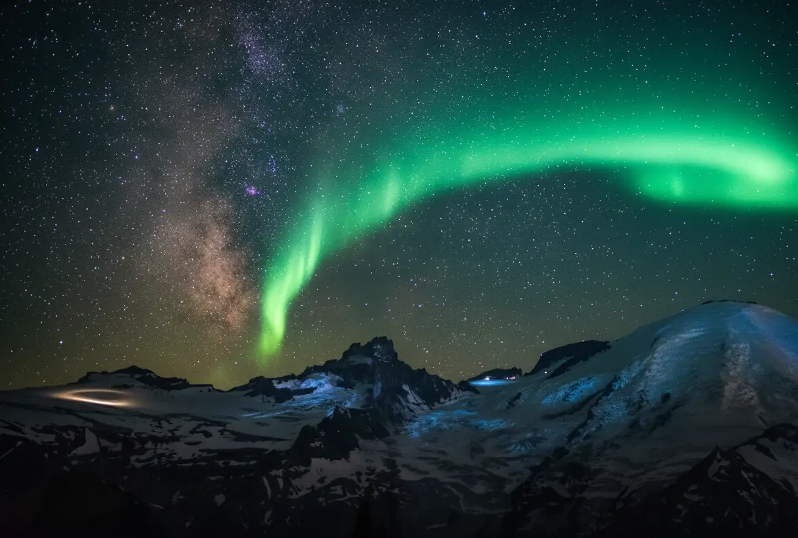 Green northern lights over snowy mountains under starry night sky, high-resolution nature wallpaper for desktop and phone