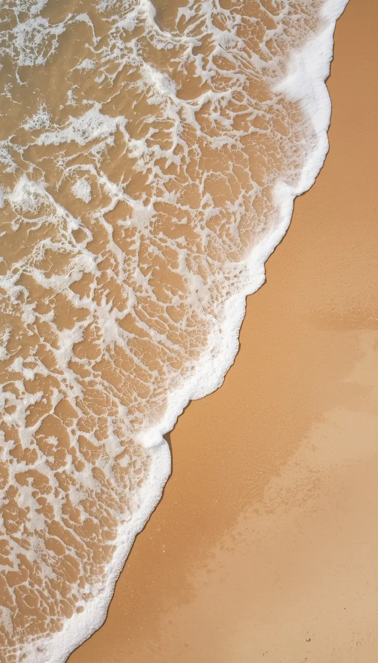 aerial view of beach waves on sand summer iphone wallpaper with soft foam and warm tones
