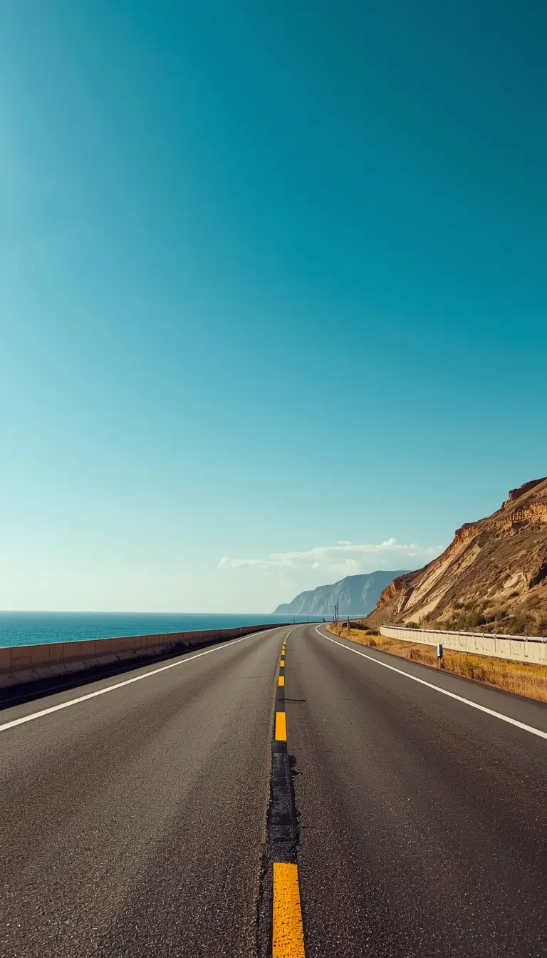 coastal highway by ocean under blue sky summer iphone wallpaper scenic road aesthetic view